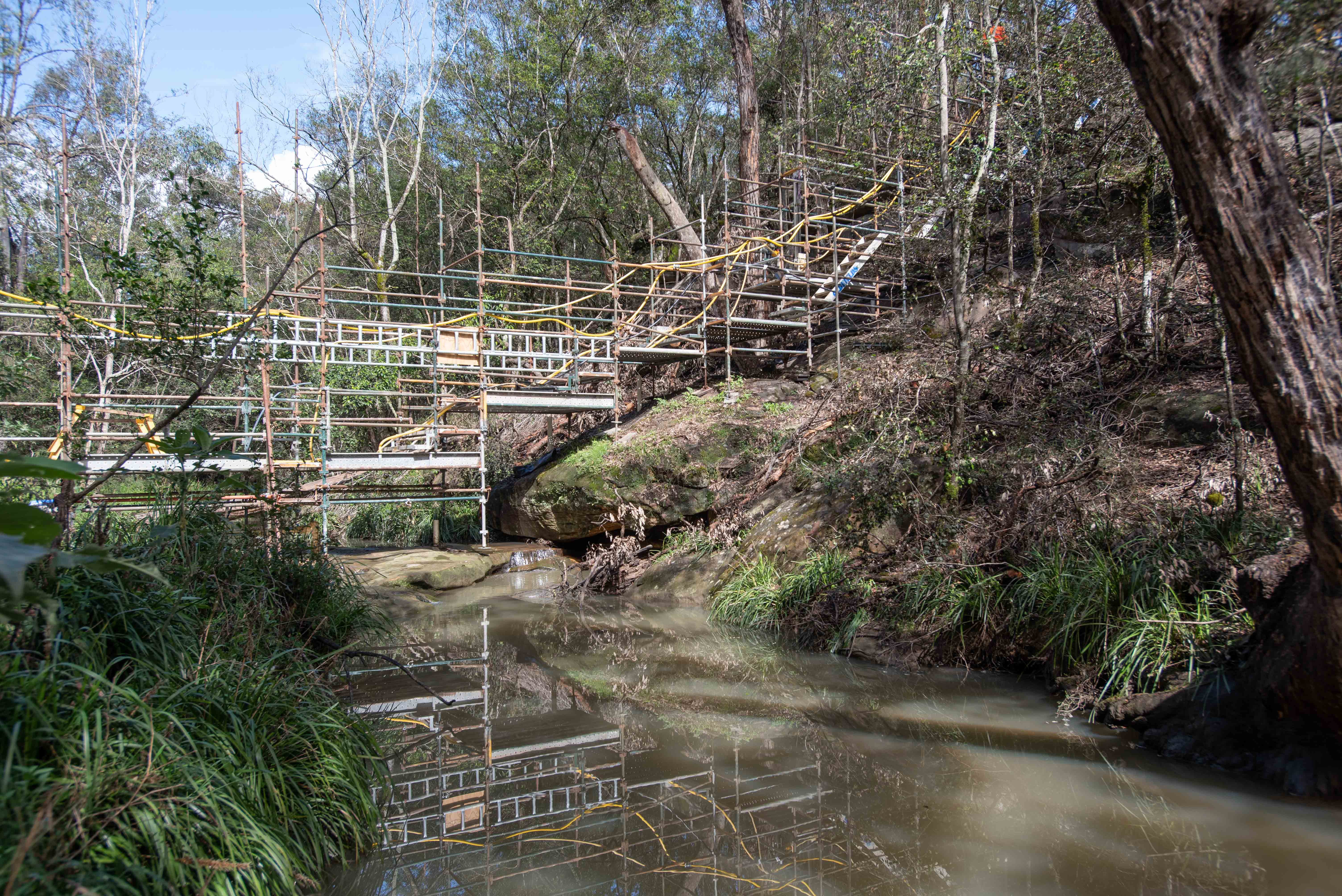 Difficult-access scaffolding over a creek bed