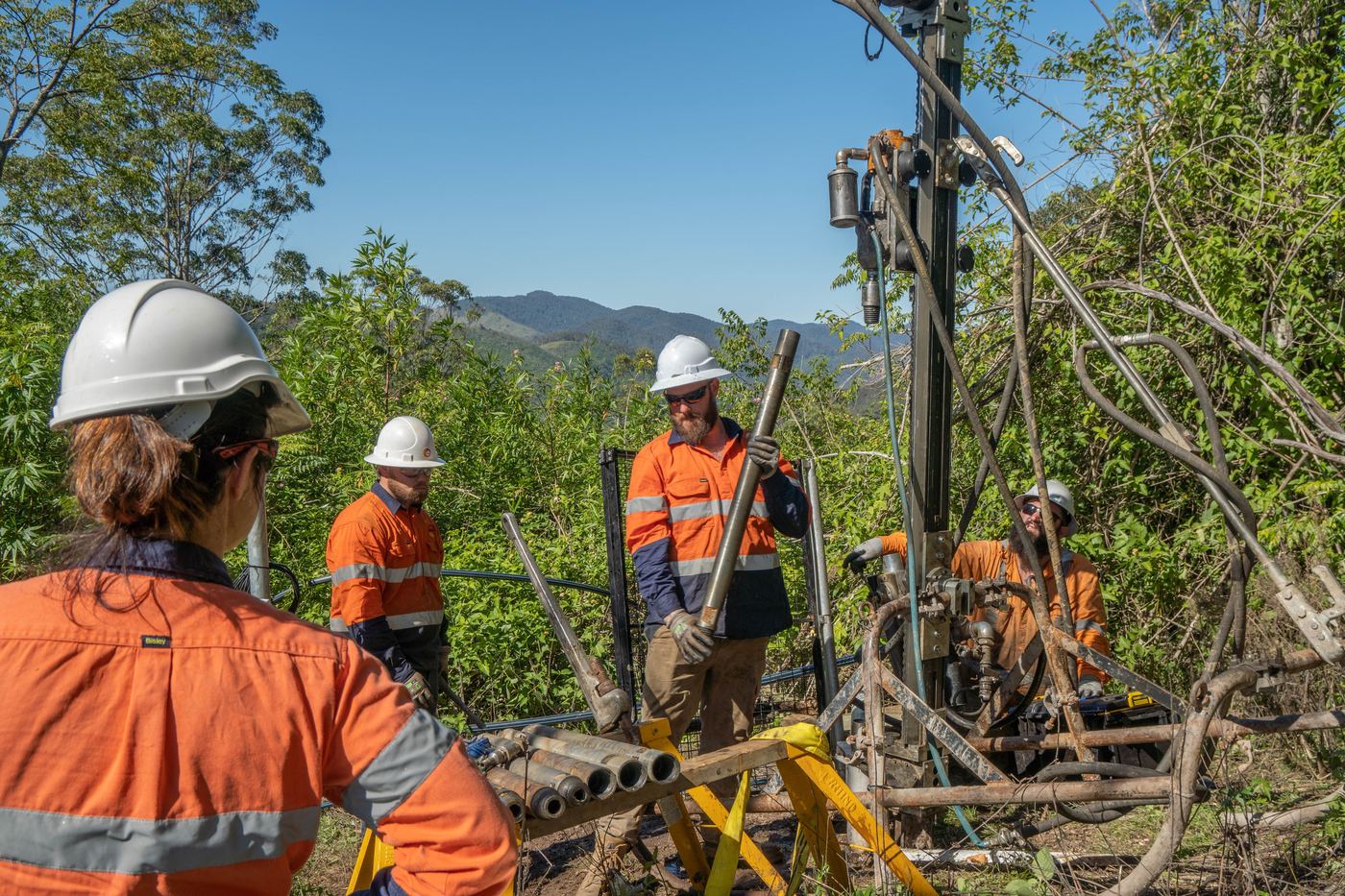 Drilling crew at a remote collar in mountain terrain