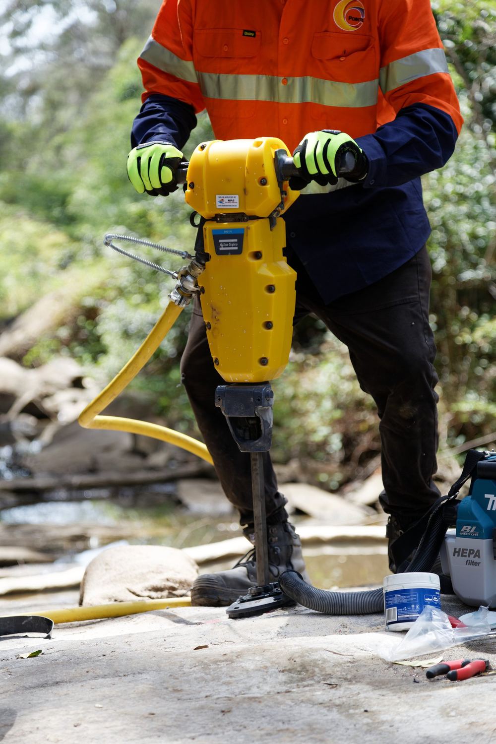 Technician operating grout injection equipment